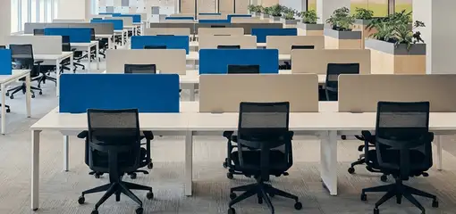 Modern open-plan office space featuring clean workstations, ergonomic chairs, and sanitized carpets provided by professional office cleaning services in Portland, OR.