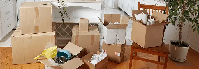 Packed moving boxes and household items in a kitchen before move-out or move-in cleaning, Portland, OR.